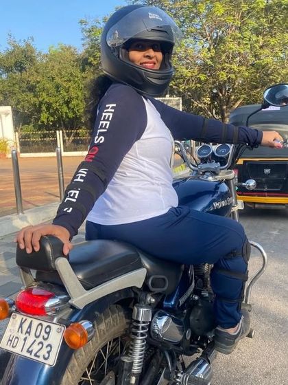 A graduate on her bike, wearing her Heels on Wheels jersey with pride. She represents the spirit of our community.