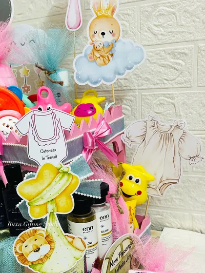 A close-up of the baby shower hamper, showing the cute cutouts and the variety of baby products inside.