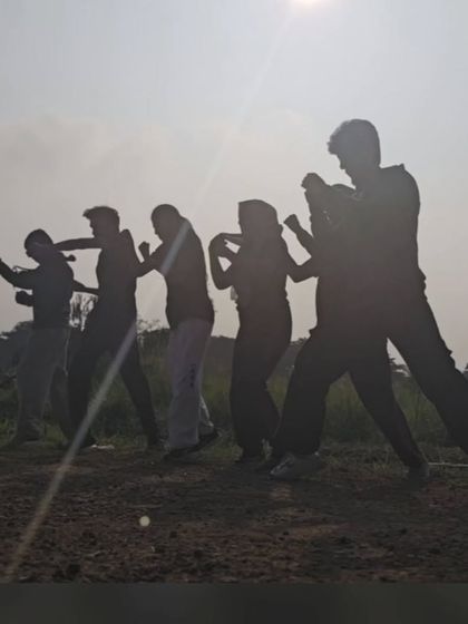 A silhouette of our team training as the sun sets. There's a unique energy when we all move and practice as one.