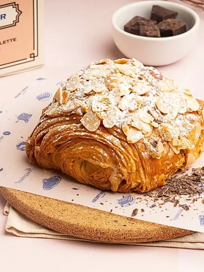 My limited edition Pain au Chocolat Almond is a true indulgence. It combines the richness of a chocolate croissant with a crunchy, nutty almond topping.