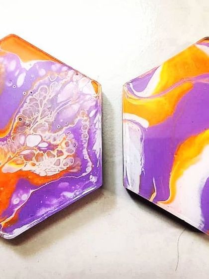 This custom coaster set was made for a client who wanted an unmatched pair. It shows that even for functional art, you can request specific colors and styles, like the mix of fluid cells and clean stripes seen here.