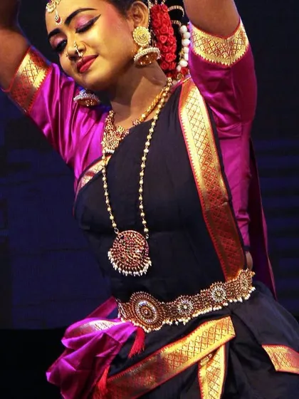 A close-up of a dancer's in a moment of serene expression, her eyes conveying a world of emotion during the 'Ayyappa Kavuthuvam'.