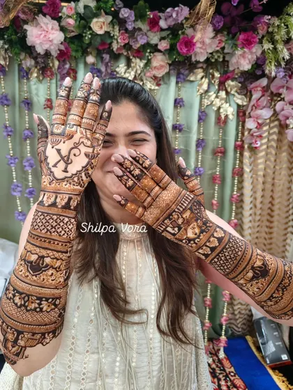 A candid shot capturing the bride's happiness with her complete bridal henna.