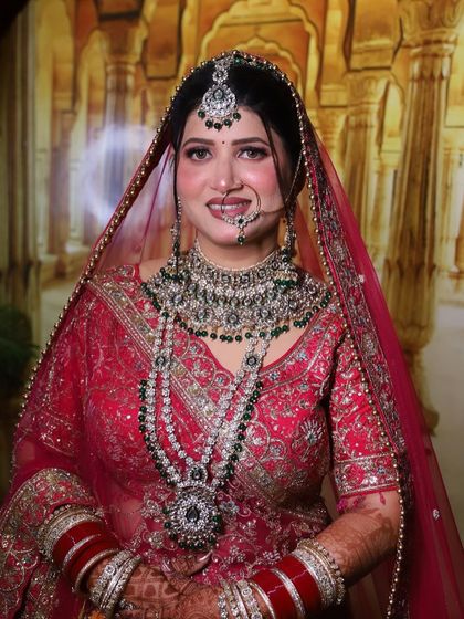 A complete bridal portrait. From the maang tikka to the layered necklaces, every detail is considered to create a cohesive and royal look.