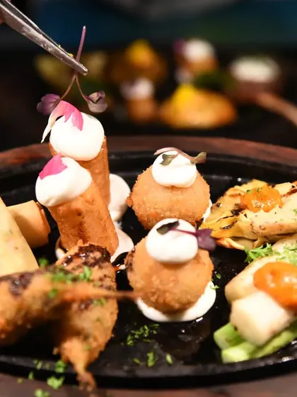 A platter of assorted tapas, showing the care and detail I put into each bite. This includes croquettes, spring rolls, and other small delicacies.