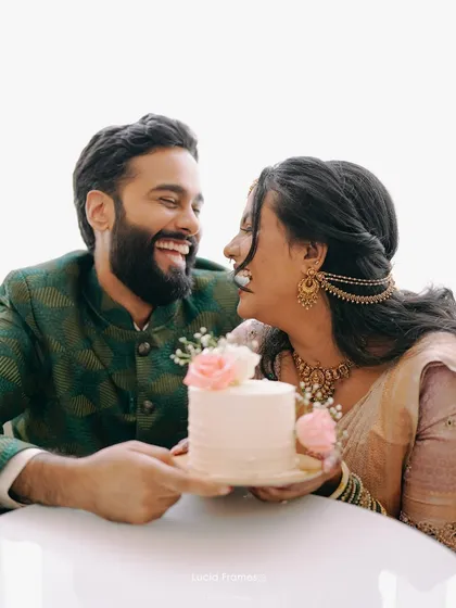 A sweet, happy moment between the couple over their celebration cake.