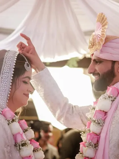 The groom applies the sindoor, a deeply significant moment in a Hindu wedding. We capture these rituals with a close, intimate perspective, focusing on the emotion and tradition.