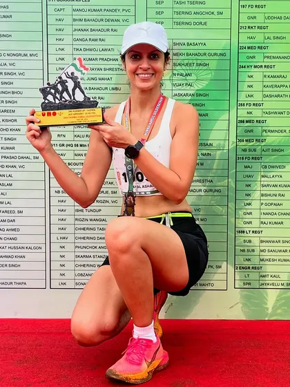 A powerful pose with a well-earned trophy. This runner's determination to finish what she started, pushing through the tough moments, is an inspiration to us all.