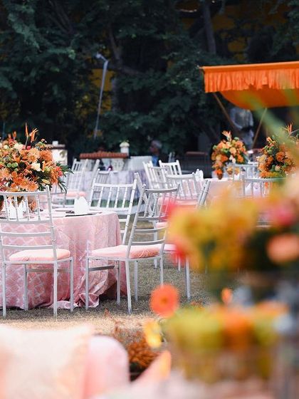 The overall layout of the garden Mehendi, showing the balance between the dining tables and the relaxed lounge seating. The entire space felt cohesive, with the peach and orange palette tying everything together.