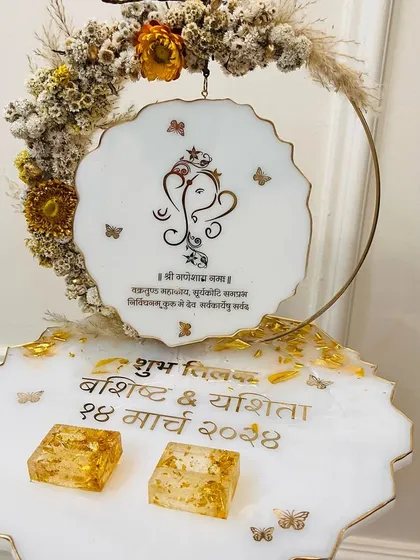A beautiful white and gold ring platter featuring a Ganesha design and Hindi text for a traditional ceremony.