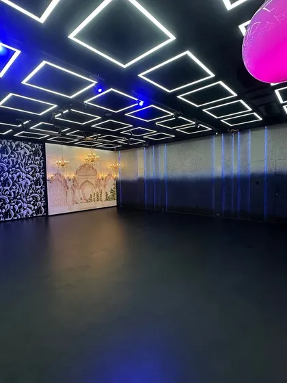 Take a look at the possibilities. This wide shot shows our main production floor where you can see the Haveli set, abstract art panels, and our signature geometric LED ceiling grid all in one frame. We designed this space so you can switch between completely different looks in minutes.