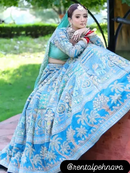 A stunning sky blue lehenga with intricate threadwork, perfect for a day wedding or a summer bride.