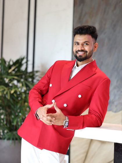 Our client looking relaxed and stylish in his custom red blazer. We ensure our garments are not just visually striking but also comfortable to wear.
