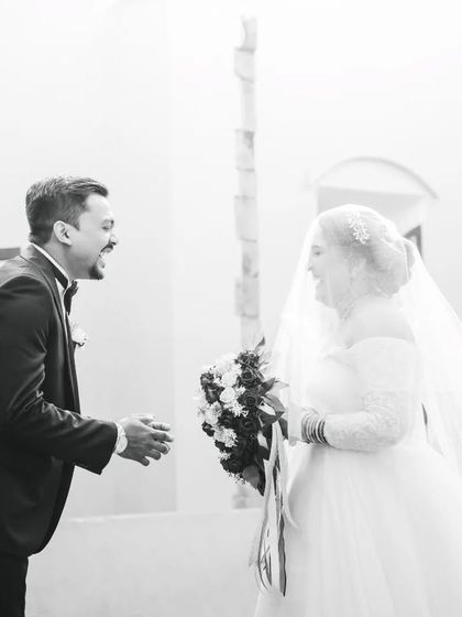The groom's joyful, laughing reaction to seeing his bride. This black and white sequence captures the raw emotion of the first look perfectly.