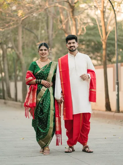 A formal portrait that radiates grace and happiness. The couple's coordinated pose and traditional attire are captured perfectly, creating a classic wedding photograph.