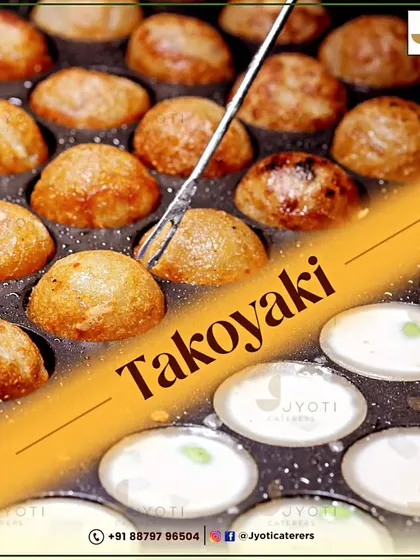 The art of making Takoyaki. These Japanese octopus balls are cooked to perfection in a special molded pan, resulting in a snack that's crispy on the outside and creamy on the inside.