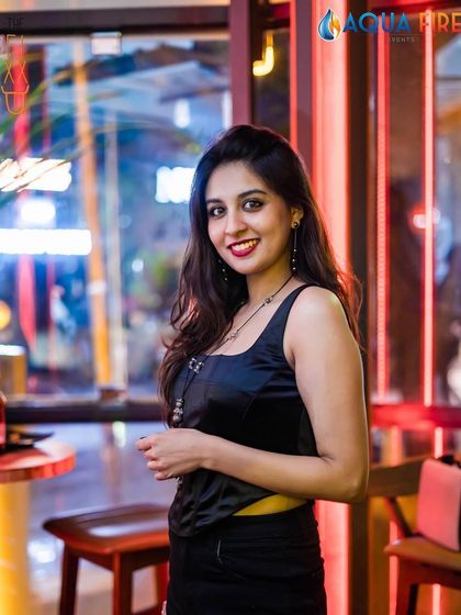 A guest smiling by the window at The Fixx Bar. The club has a great ambiance both inside and out.