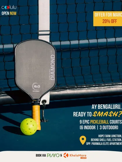 This shot focuses on the details that matter. A high-quality pickleball paddle and ball rest against the net on one of my pristine courts in Whitefield. It shows my commitment to providing top-notch facilities and equipment for the best possible playing experience.