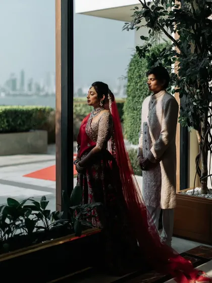 A quiet, shared moment overlooking the Mumbai skyline from the Trident Nariman Point. This shot perfectly blends the intimacy of the couple with the grandeur of their urban wedding destination.