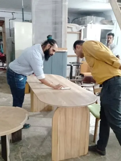 Here I am with a client, inspecting the finish on his new ashwood dining table. I believe in a hands-on approach and walking clients through the details of their custom-made pieces.