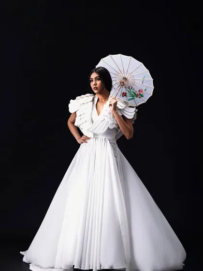 An avant-garde look for an editorial concept titled "YUME". The makeup and hair are clean and minimal to complement the sculptural white gown and artistic direction of the shoot.