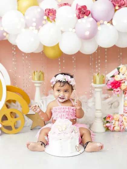 A princess-themed cake smash fit for royalty. With a beautiful pink carriage and a frosting-covered smile, this little one is celebrating her first birthday in the sweetest way possible.