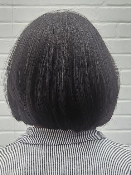 The back view of a perfectly executed classic bob. The clean lines and precise shape create a timeless and sophisticated look.