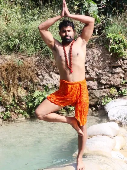Another variation of Tree Pose, this time with traditional attire. This pose symbolizes stability and growth, reminding us to stay rooted while reaching for our highest potential.