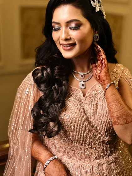 A close-up showing the glittery eye makeup and soft curls. This is a classic combination for a glamorous evening event.