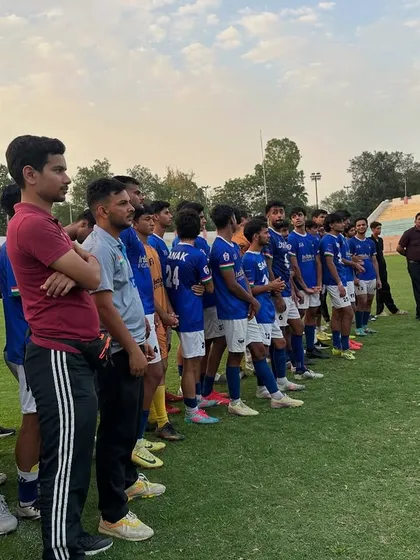 The calm before the storm. The team lined up, waiting for the trophy presentation after a hard-fought season. This is a moment of pride for the entire club.