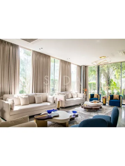 Our design for House Retold reimagined an older home by opening it up to its quaint garden. We used expansive glazed doors to dissolve the boundary between the living room and the outdoors, transforming the space into a place of quiet connection with nature. This seamless flow invites light and greenery deep into the home.