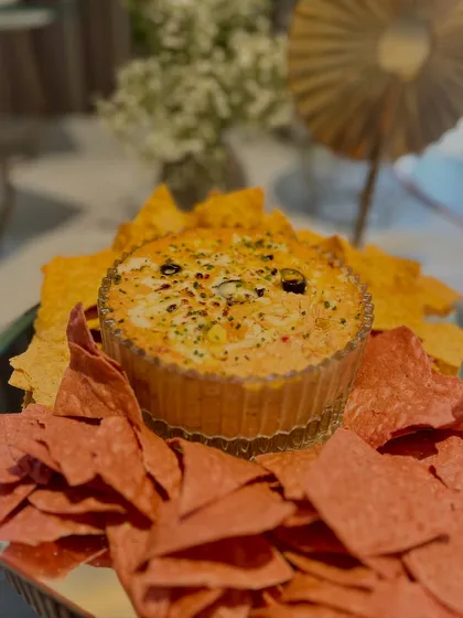 Our Spicy Pizza Paneer Paprika Dip, served with a variety of colourful nachos, a perfect centerpiece for a casual yet chic gathering.
