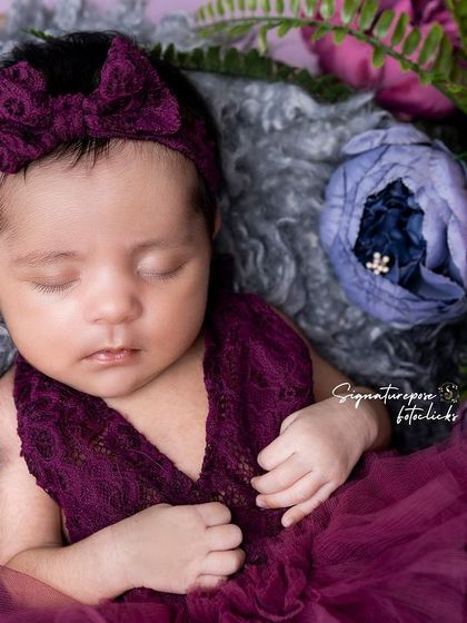 A duplicate of image 23, a beautiful floral newborn portrait.