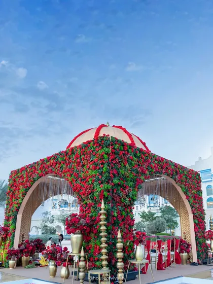 A breathtaking floral mandap at Salwa Beach Resort, Doha, completely covered in red flowers with a domed top, embodying the grandeur of our "Royal Rajputana" theme.