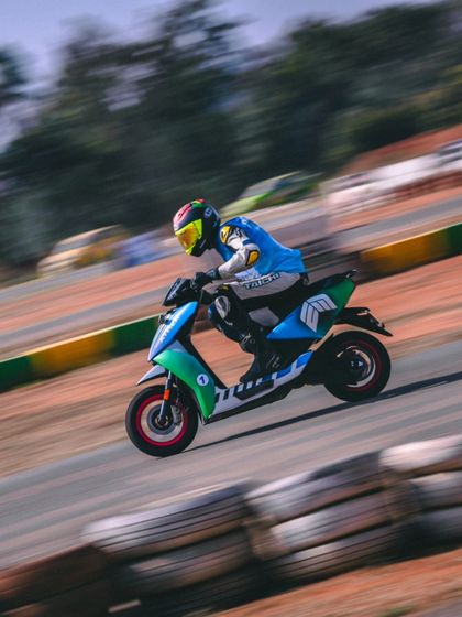 A pan shot showing the speed of an electric scooter on the track. The instant acceleration makes for exciting and close racing.