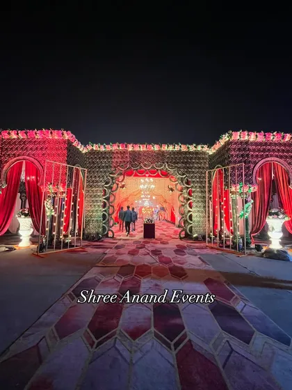 A magnificent, palace-like entrance structure with intricate metalwork, draped in red curtains, creating a truly royal welcome.