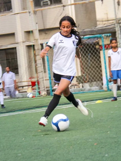 A powerful kick towards the goal shows passion and purpose. Our training for older girls in the U12 and U14 batches focuses on translating practice into powerful game-day performance.