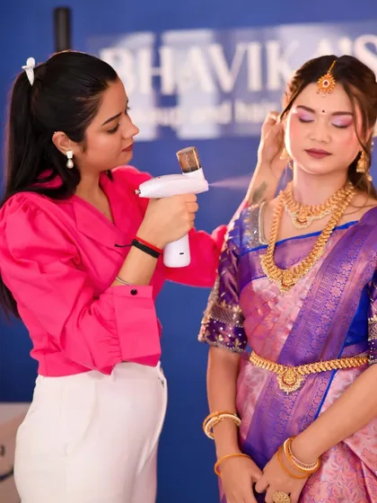 A photo of me demonstrating airbrush makeup on a model, explaining its benefits for a flawless, long-lasting finish.