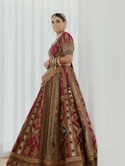 A full-length portrait of the bride in her magnificent Marwar Couture lehenga. The craftsmanship, color combination, and fit were all customized to her vision.