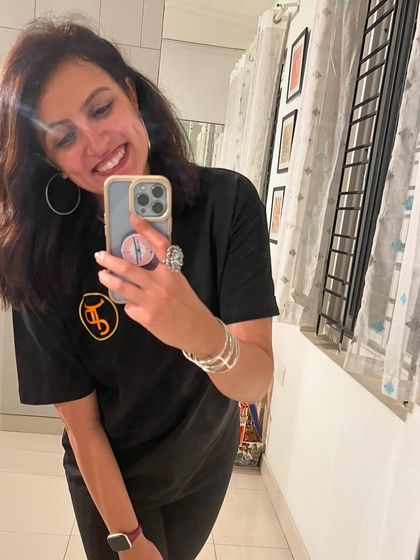 The post-show glow is real. Here I am in my company t-shirt, feeling grateful and excited after a successful sangeet show.