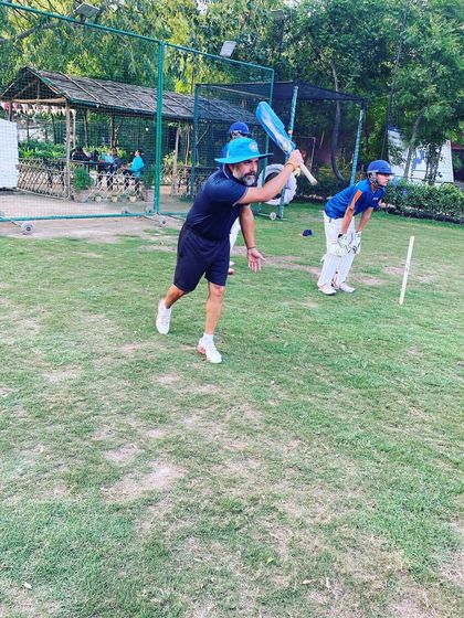 A snapshot from our fielding drills, with a coach hitting catches to the players. Repetition is key to making catching feel natural.