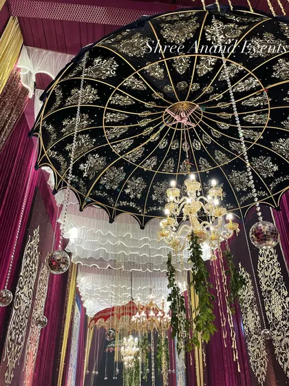 It's all in the details. This intricate ceiling decor, featuring a custom-designed black and gold umbrella, hanging crystals, and disco balls, shows our commitment to creating a multi-layered, visually rich environment.