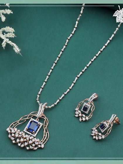 The Sapphire Dream set, a deep and spellbinding design. A central square-cut sapphire is cradled within an intricate rose gold frame, accented by a spray of marquise and round diamonds.