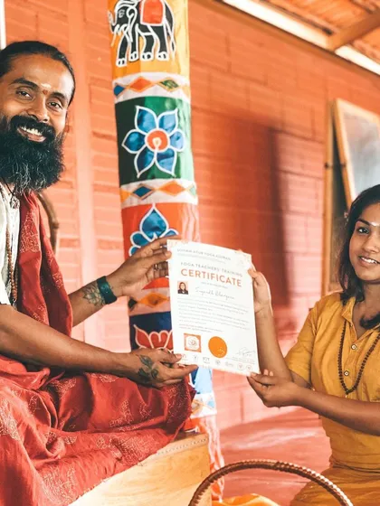 Another happy graduate receives her certificate. This moment marks the end of one chapter and the beginning of a new one as a certified yoga teacher.