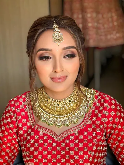 A beautiful portrait of the bride. The soft waves around her face enhance her features and her glowing makeup.