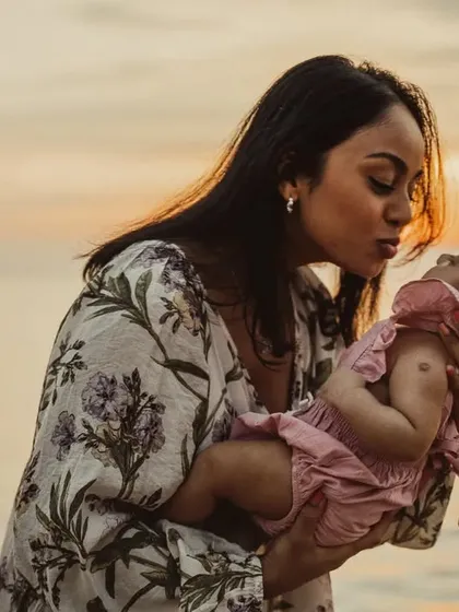 A tender moment between a mother and her new baby, captured against a beautiful sunset. Outdoor lifestyle sessions like this allow for natural, emotional connections that tell the story of your family's love.