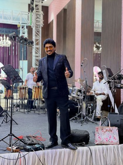 On stage with the band, ready to rock the event. A live band adds a whole different level of energy to any celebration.