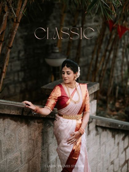 Classic. A portrait of the bride in a timeless Kanjeevaram saree, her elegance enhanced by the rustic, traditional setting.