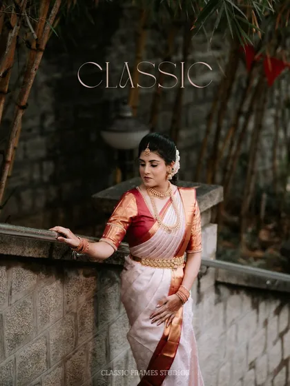 Classic. A portrait of the bride in a timeless Kanjeevaram saree, her elegance enhanced by the rustic, traditional setting.