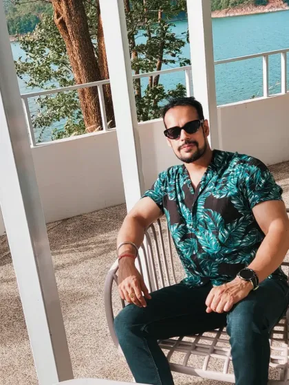 Keeping the chill mood on. Relaxing by the water in Thailand, showing that a fitness lifestyle includes moments of leisure and rest.